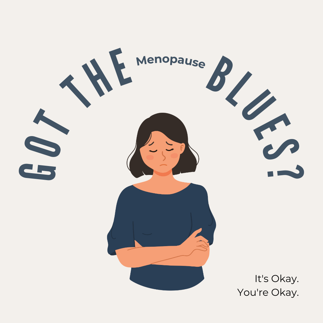A midlife woman standing with her arms around her chest. She is sad and has her head down. Text: Got the Menopause Blues? It's okay. You're okay.